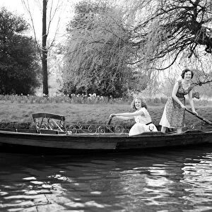 Two girls in a rowing boat on a trip on the river Circa 1954