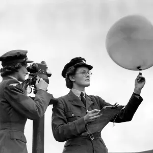 Girls of the WaFs with the theodolite and balloon for meterological observation at an Girls of the WaFs with the theodolite and balloon for meterological observation at an