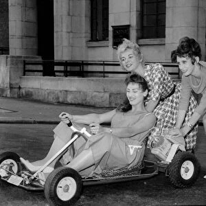 Three girls from the Windmill Theatre in London play around on a go kart, July 1960