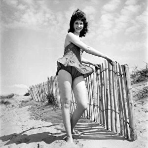 Glamour Girl. Barbara Stockton, 19 seen here posing on the beach. June 1960 M4295