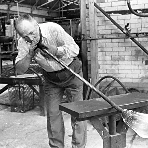 Glass blower Bill Tremble is tube drawing a glass bulb in July 1987