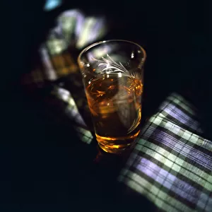 A glass of single malt whisky Tartan Scotland Circa 1970