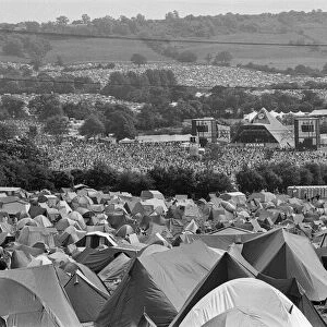 Glastonbury Festival, Pilton, Somerset. Picture shows scenes from the 1993 festival. Hundred of tents and thousands of people enjoy the music from The Pyramid Stage seen in the distance