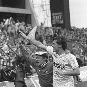 Glenn Hoddle running with a fan on the pitch after the match