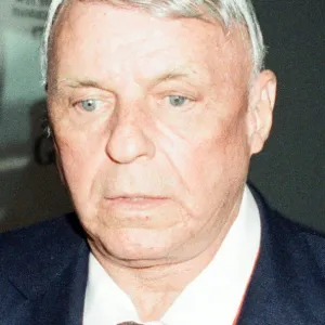 A glum looking Frank Sinatra seen here arriving at Heathrow Airport at the start of his