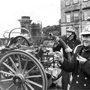 Goeff and Robin dressed as Victorian Firefighters with a fire engine of that era at