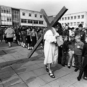 Gordon Simpson carries a 7ft wooden cross during the traditional Procession of Witness