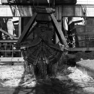 The grab crane, rises out of the ash settling tank, drawing off the ash at the Aberthaw A