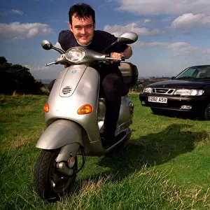 Grant Scott on a Vespa Scooter and Saab 9. 3 September 1998