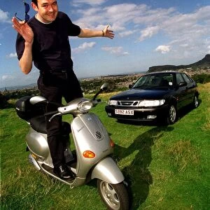 Grant Stott standing on Vespa scooter September 1998