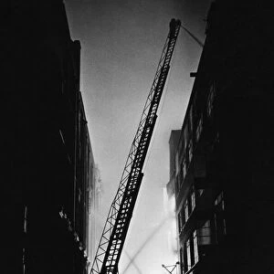 The Great Fire of London. Personnel and turntable ladders at work on the city fire