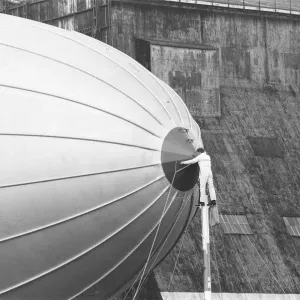One of the ground crew prepares to detach the Goodyear airship Europa from her mooring
