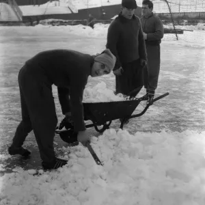 Grounds staff at Bristol Rovers Eastville Stadium struggle to clear snow from the pitch Grounds staff at Bristol Rovers Eastville Stadium struggle to clear snow from the pitch