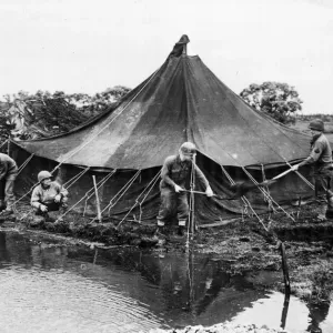 A group of American soldiers build a dam to keep the river from flooding after it burst A group of American soldiers build a dam to keep the river from flooding after it burst