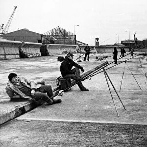 A group of anglers enjoying a spot of fishing on the pier at the mouth of the River Wear