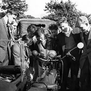A group of boys and men looking at a motorcycle during the Tyneside Summer Exhibition