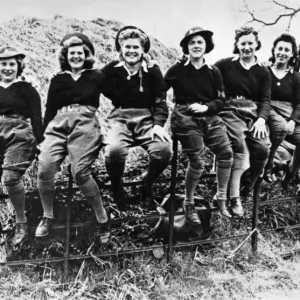 A group of happy looking Land Army girls pose for a group photograph during the Second