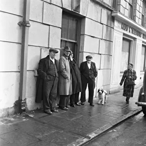 Group of miners standing outside the Boot Hotel in Aberdare, South Wales 1st March 1954
