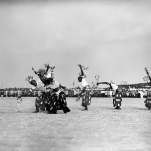 A group of Nigerian dancers who are performing in traditional costume for Queen Elizabeth