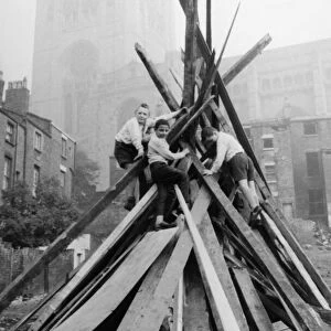 A group of schoolboys seen here adding the final touches to their bonfire in the shadow