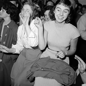 A group of women sitting down hand jiving Circa 1955