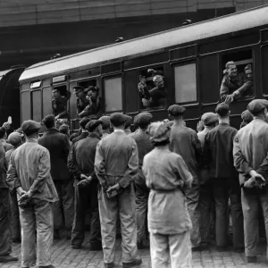 A group of workmen cheering some of the repatriated and wounded prisoners who were able
