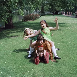 Group of four young girls playing in their local park. Circa 1970