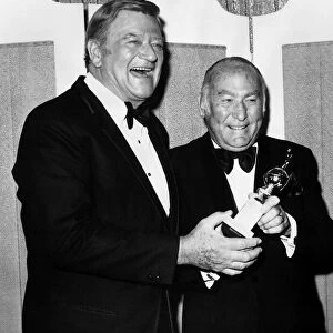 Hal Wallis film producer accepts Cecil B De Mille award 1975 from actor John Wayne