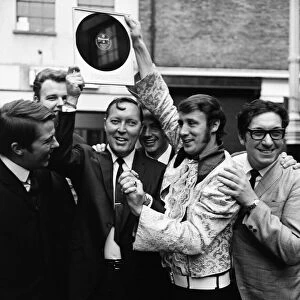 Bill Haley of the Comets, on a tour of Britain, is presented by Freddie Lee with an