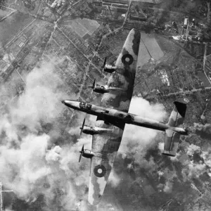 A Halifax bomber of RAF Bomber Command in flight over the target area during a raid