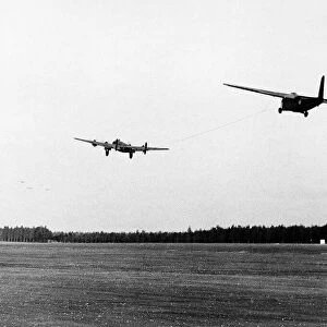 Halifax bomber towing a glider takes off from English airfield as part of the Allied