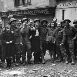 A happy group of British troops and French civilians photographed in Caen following A happy group of British troops and French civilians photographed in Caen following