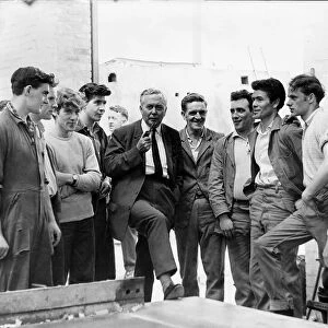 Harold Wilson MP talking with workers at the stock yard of unit construction as he opens