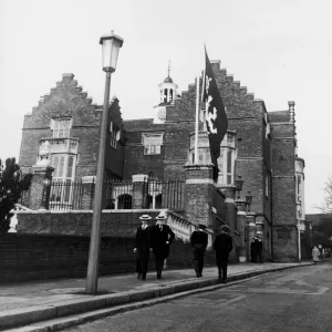 harrow schoolboys wearing their school uniform pass by the side of the college