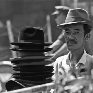 Hat seller at the flower market in Saigon on the eve of the Tet celebrations Hat seller at the flower market in Saigon on the eve of the Tet celebrations