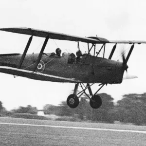 A de Havilland Tiger Moth landing on an airfiield. 02 / 07 / 1977 A de Havilland Tiger Moth landing on an airfiield. 02 / 07 / 1977