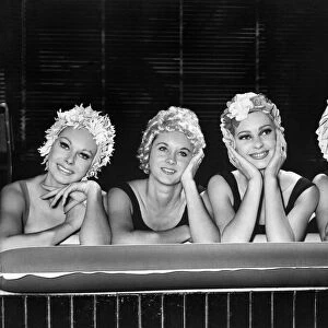 Four heads with a single thought, girls wearing summer swimwear. October 1962 P007855