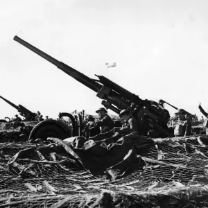 A heavy anti-aircraft battery in action on the South East Coast during an air attack A heavy anti-aircraft battery in action on the South East Coast during an air attack