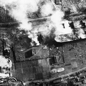 Heavy damage to Kassel after an R. A. F. raid. Pictured, five fires still burning among
