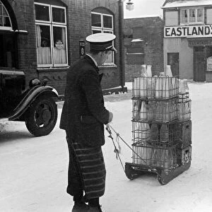 The heavy fall of snow overnight sees the milkman delivering his milk by sledge