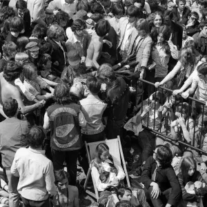 Hells Angels help pass a collapsed fan forward to the fist aid attendants at free Rolling Hells Angels help pass a collapsed fan forward to the fist aid attendants at free Rolling