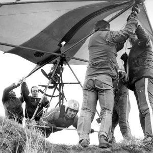 Helping hands get Gordon Smith ready to take to the air in his Hang Glider in April 1978