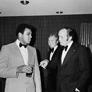 Henry Cooper fooling around with fellow boxer Muhammad Ali at a press conference in