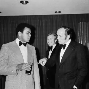Henry Cooper fooling around with fellow boxer Muhammad Ali at a press conference in