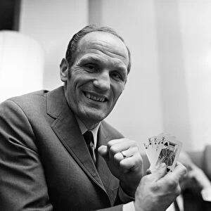 Henry Cooper holding four kings, relaxing playing cards in a Hampstead hotel