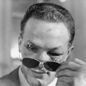 Henry Cooper, the new British and Empire Heavyweight boxing champion looks from behind