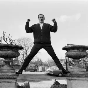 Henry Cooper, pictured standing astride two ornamental flower pots in the garden of Henry Cooper, pictured standing astride two ornamental flower pots in the garden of