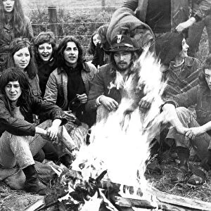 Some hippies sitting round a campfire in May 1971