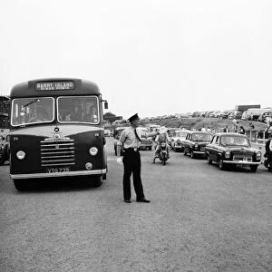 Holiday Crowds at Barry Island: Two Barry policeman control the dangerous crossing point