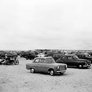 Holiday makers and their cars on Southport beach, Merseyside. 5th August 1959